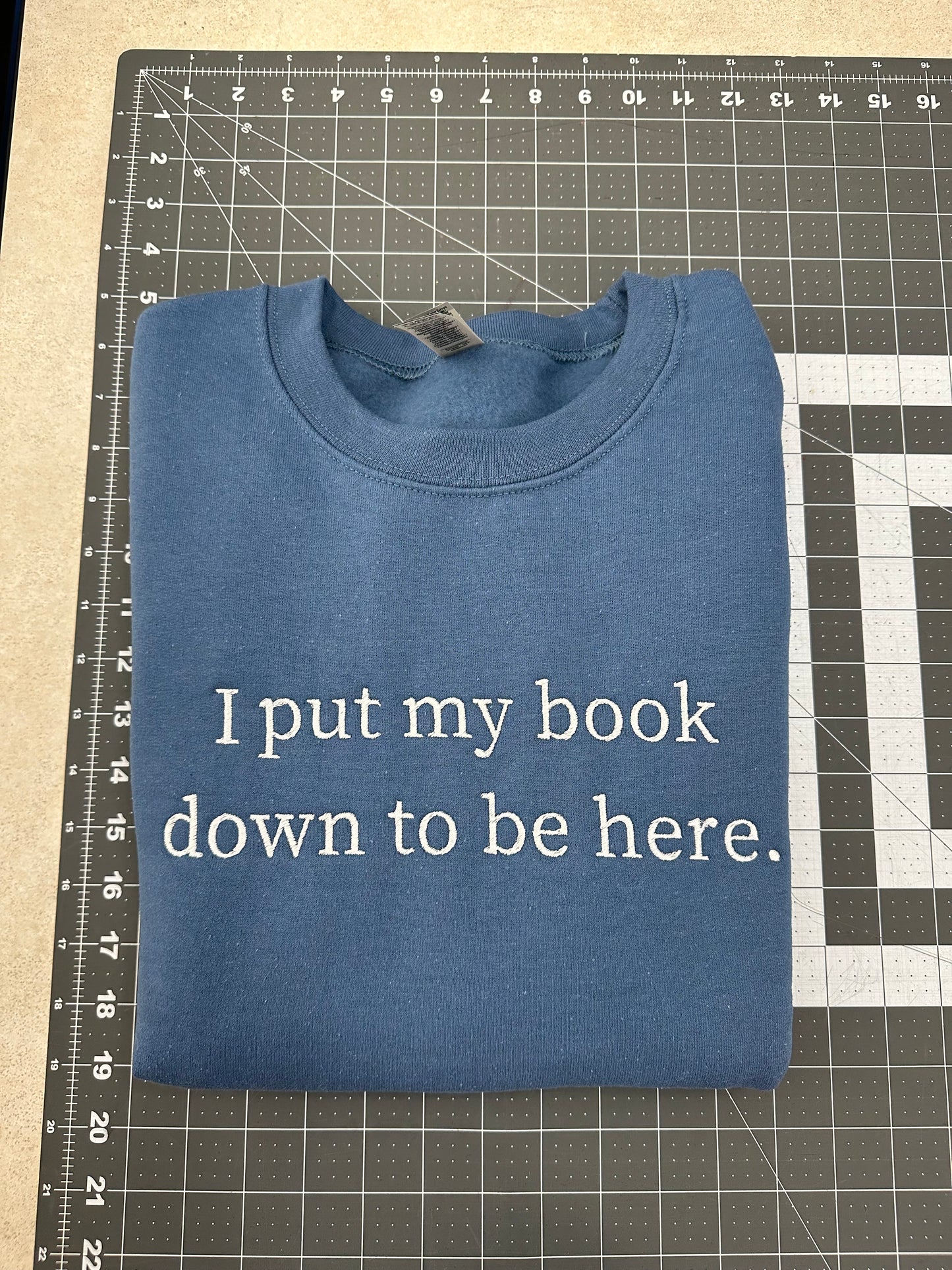 Oopsie Embroidered I Put My Book Down To Be Here Sweatshirt (Medium)