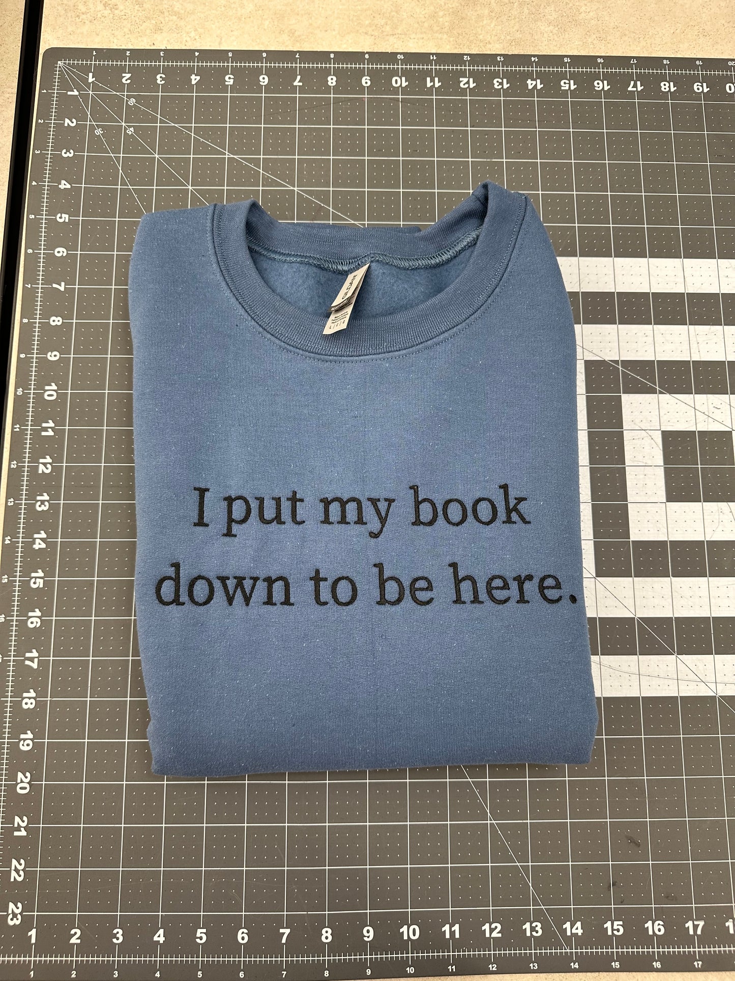 Oopsie Embroidered I Put My Book Down To Be Here Sweatshirt (Large)