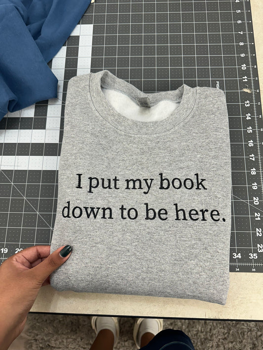 Oopsie Embroidered I Put My Book Down To Be Here Sweatshirt (Medium)